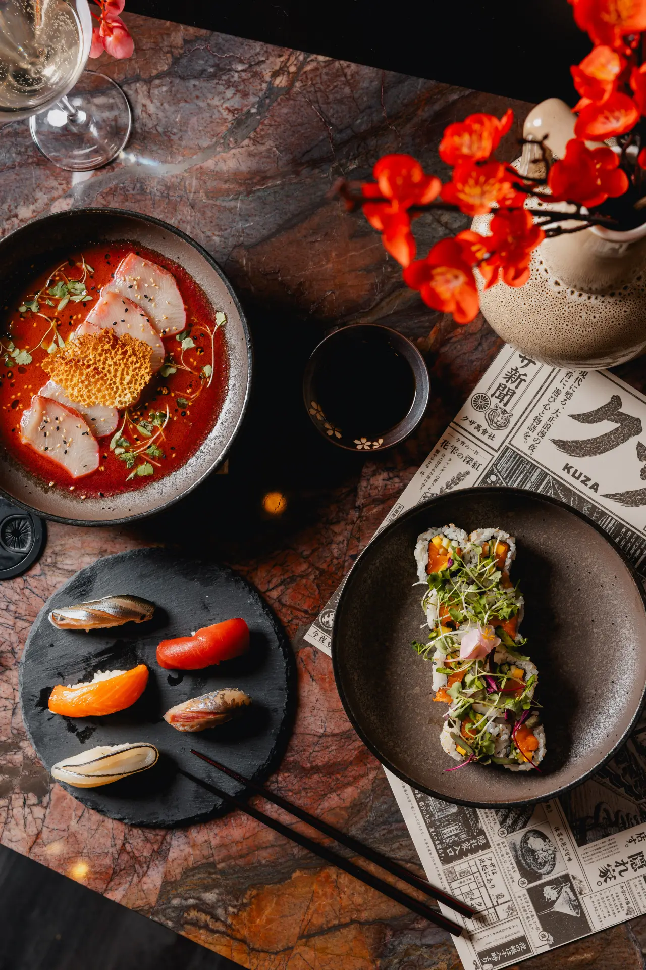 Sushi, sashimi and cocktails spread across a table