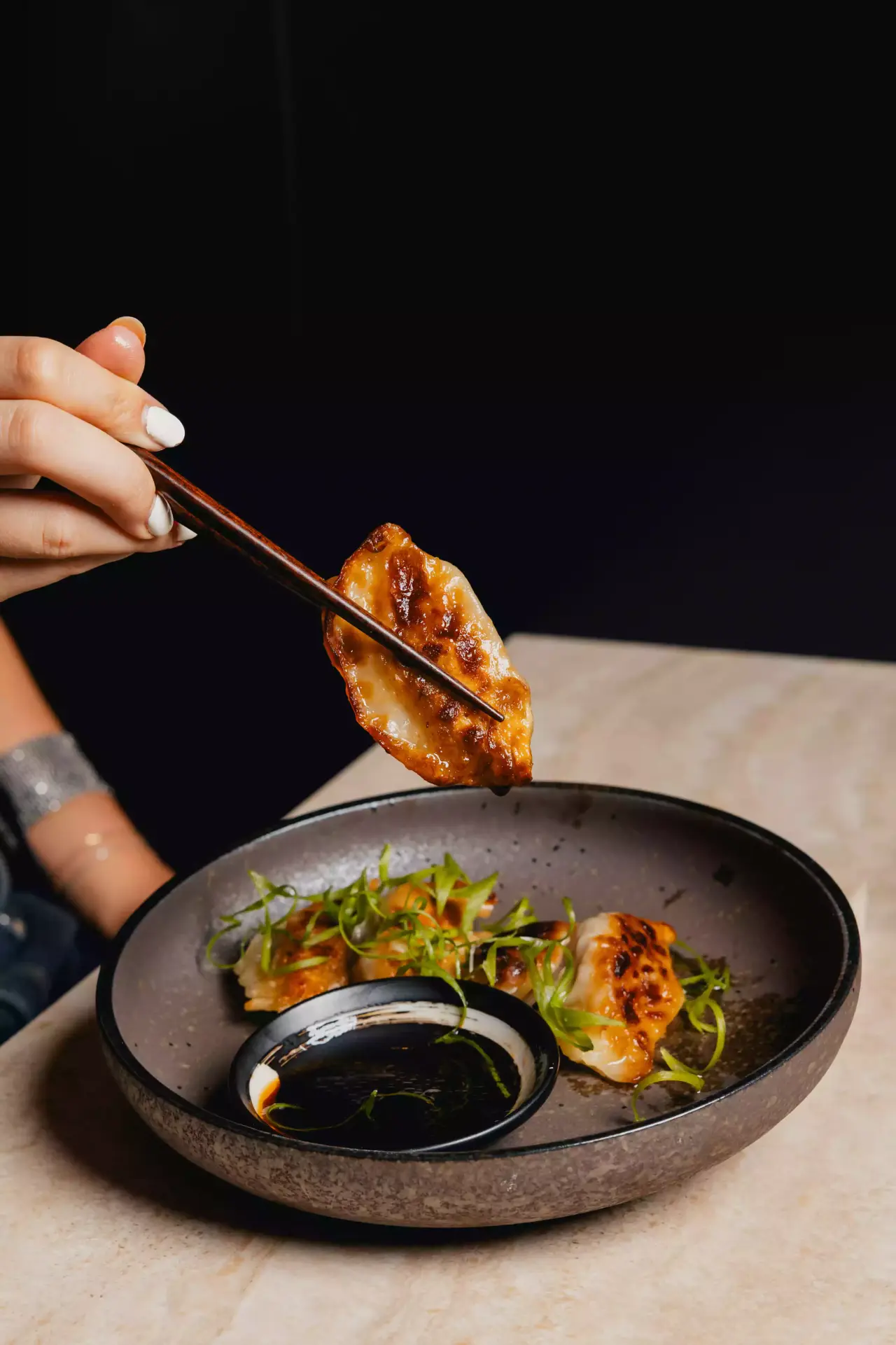 Pan-fried gyoza with chopsticks and soy sauce
